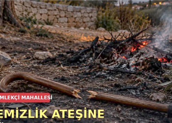 Yerde kırılmış bir baston ve arkada yanan temizlik ateşi.