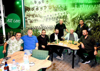 Asi Cafe'de Bodrumspor posteri önünde oturan bir grup erkek.