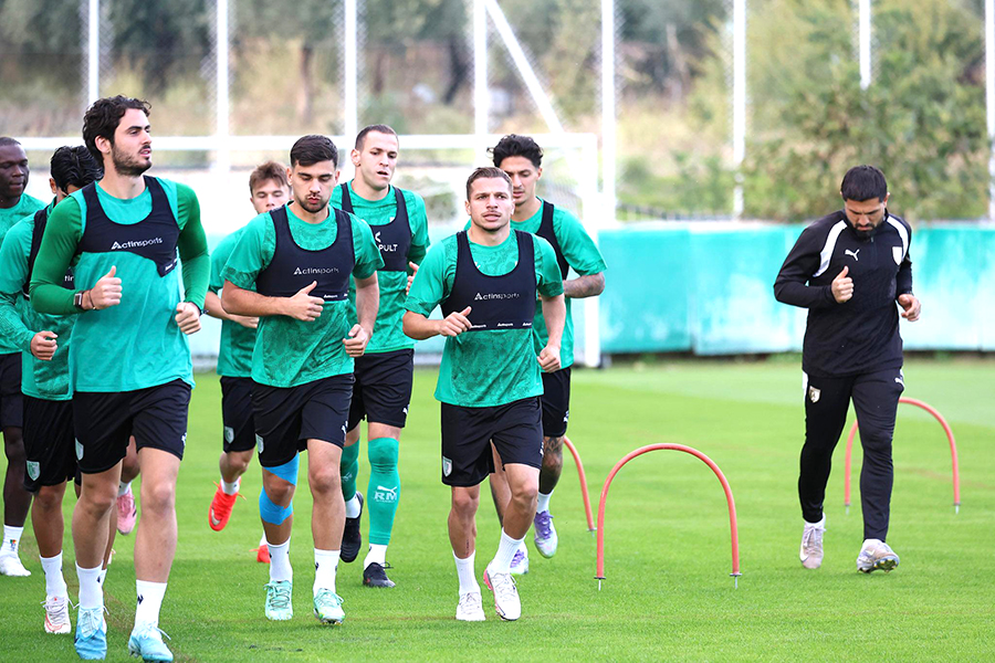 Yeşil formalı futbolcuların antrenman sahasındaki hazırlık koşusu.