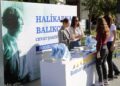 Halikarnas Balıkçısı temalı tanıtım standında broşür dağıtan görevliler ve ziyaretçiler.